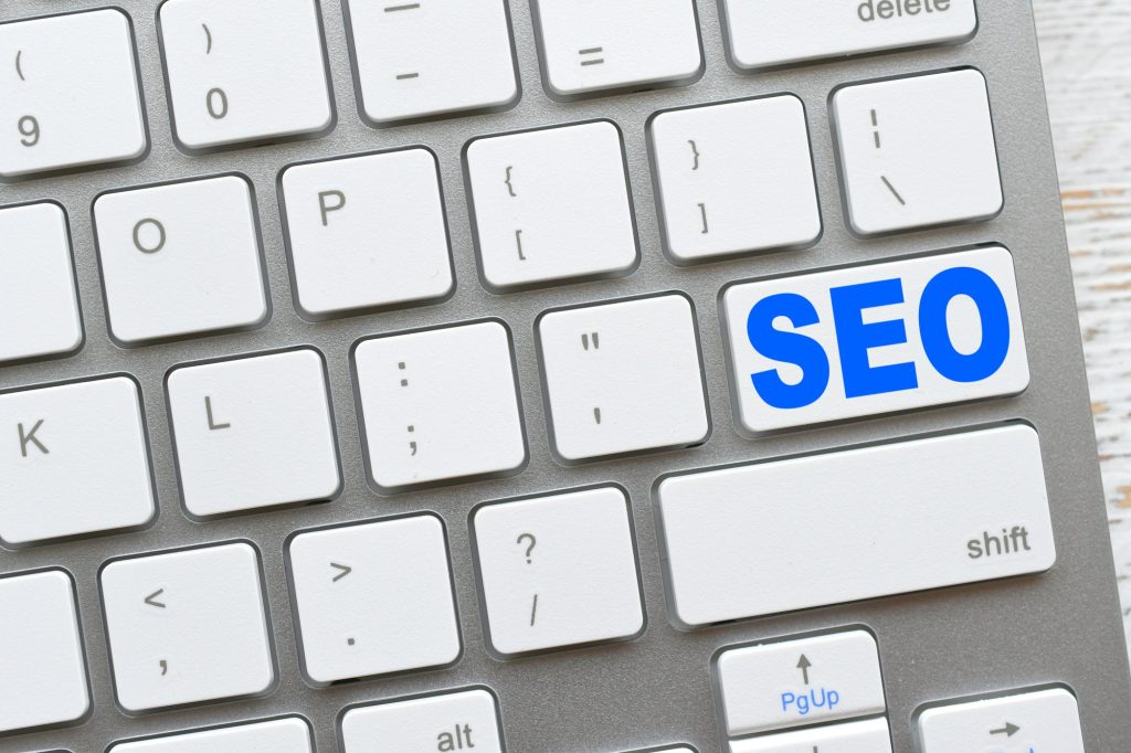 Search engine optimization concept - SEO key on a white computer keyboard.