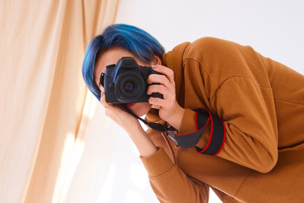 world photography day concept. woman portrait with camera in hands, photoghrapher in work